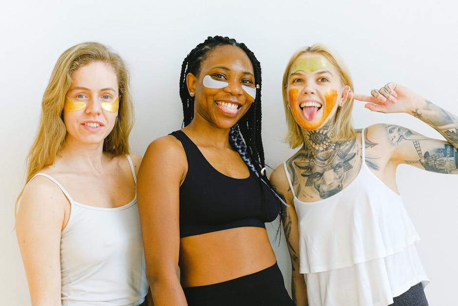 Excited young women smiling and looking at camera while having fun during weekend having beauty procedure