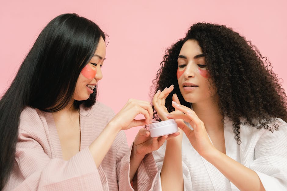 Two women with facial patches apply skincare cream