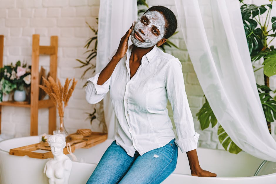 A woman enjoying a skincare routine with a clay face mask