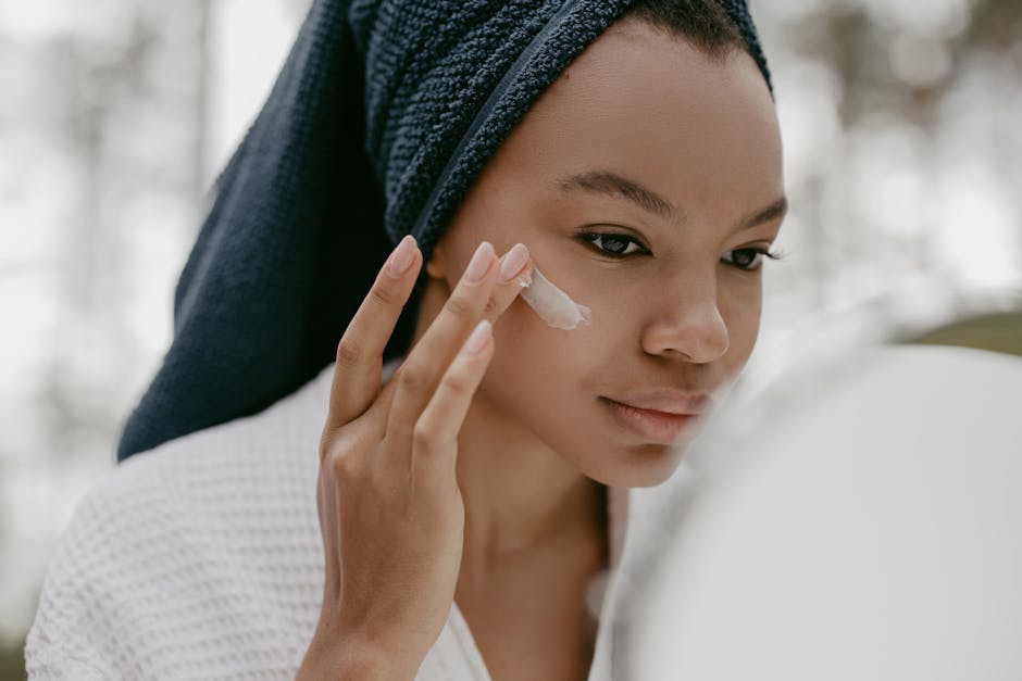 Woman gently applying facial cream in skincare routine, focusing on healthy skin