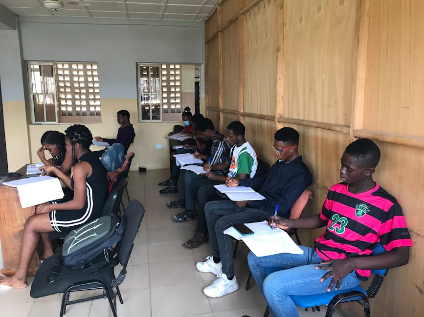 A group of students attentively participating in an educational class session indoors.